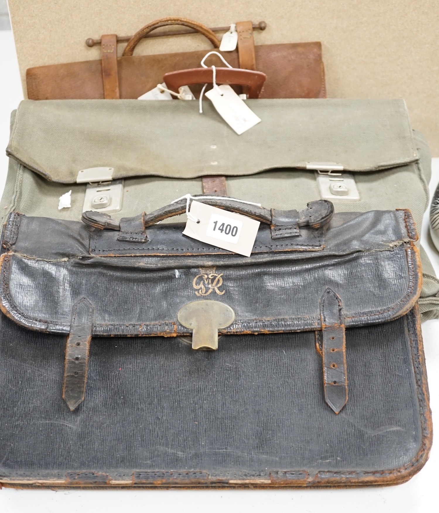 A satchel with George the VI monogram, a German Third Reich style satchel, a quantity of wartime maps and another satchel